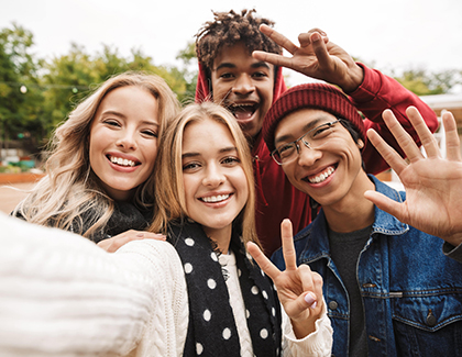 A group of young people taking a selfie.