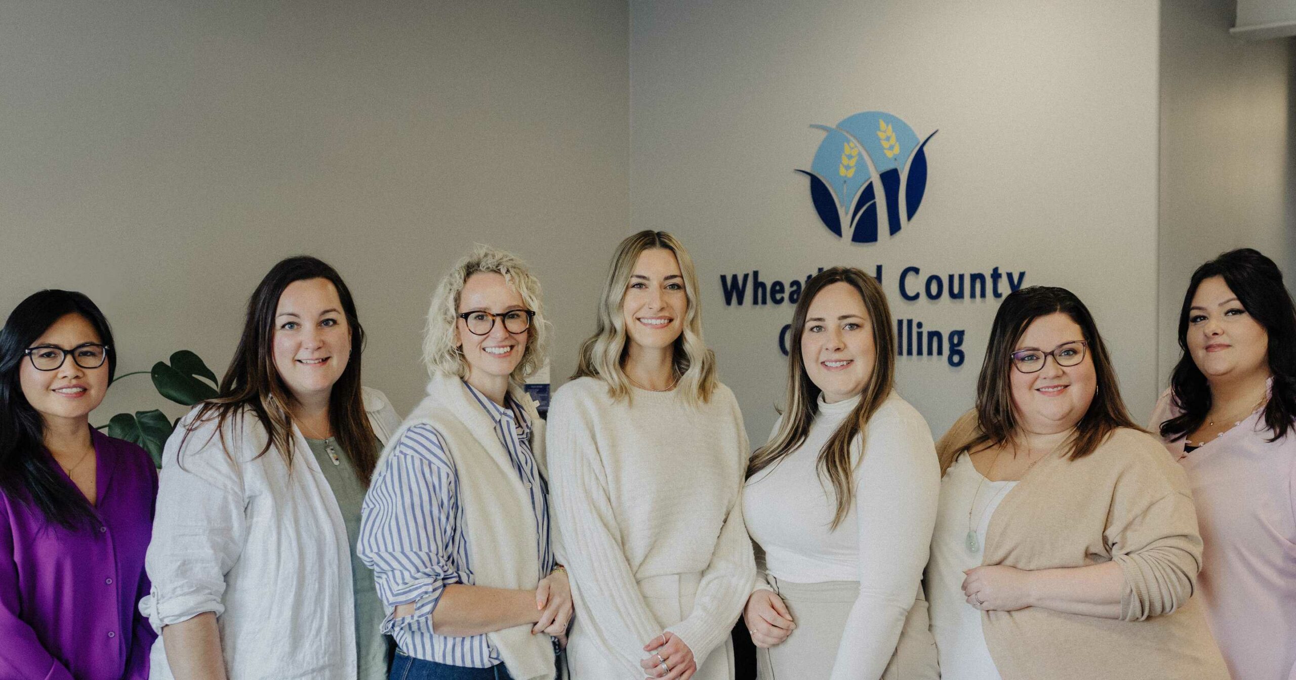A group of women posing in front of a sign that says wilmington county counseling.